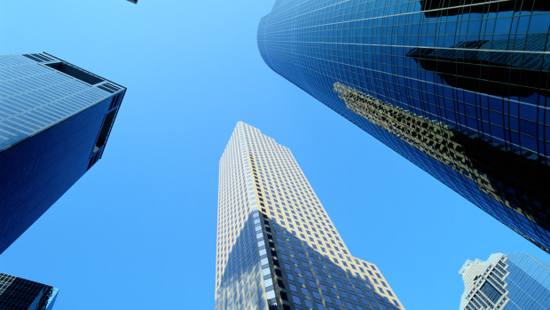 Photograph from street view, looking up at office skyscrapers.